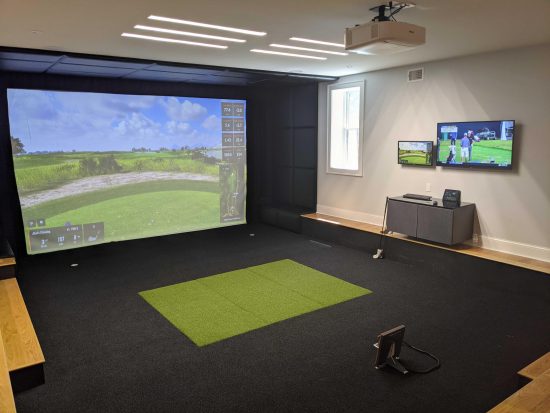 golf simulators - Black putting green flushed with hitting mat and signature pads